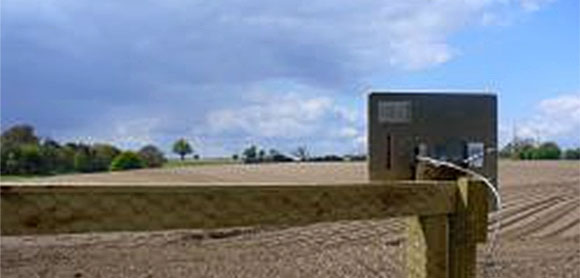 Rural wifi transmitter mounted on a fence.